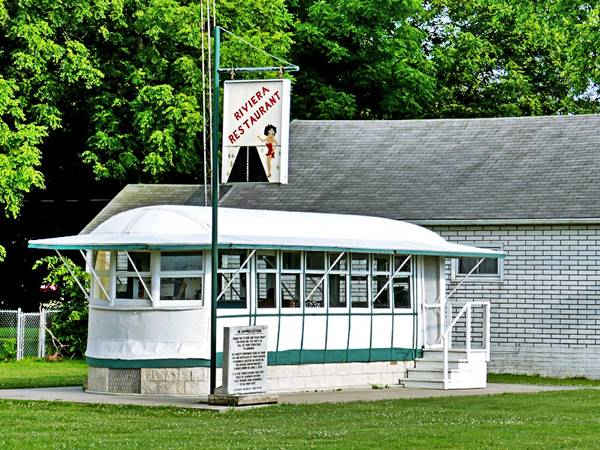 Streetcar turned into a diner in a park and a Betty Boop sign by it