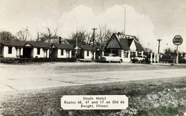 cottage style Cities Service gas station with sign and pumps, MOTEL written on its roof, motel units behind with gable roof. Cars, highway. Sepia postcard c.1952