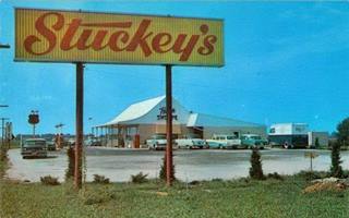 Lexington Stuckey’s vintage postcard color c.1950s postcard photo: Stuckey’s sign yellow and red cars, pumps, drive