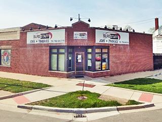 Students former gas station red brick, single story, corner building, a former gas station, cars