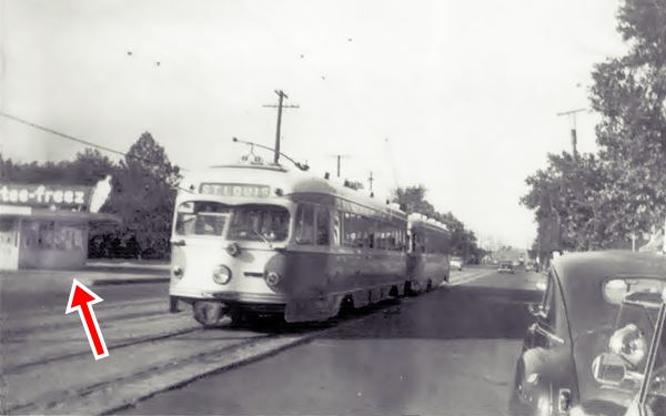 black and white 1950s photo of Broadway St., a 1930s car, a streetcar and a Tastee-Freez