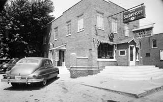 The Curve Bar 1940s black and white, 1940s brick tavern 2 stories, with Bud sign, snow