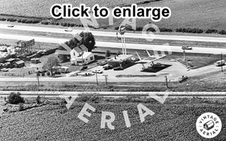 1971 view Towanda Gulf station Black and white 1971 aerial view gas station by fork on 4-lane US66 running across image (top), canopy, Gulf sign, office, cars, railroad runs along the bottom
