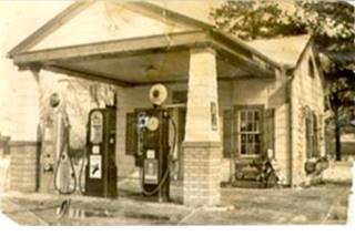 1930s Ambler Texaco station 1930s sepia, woodframe gable roof building and canopy with two box columns over 3 gas pumps
