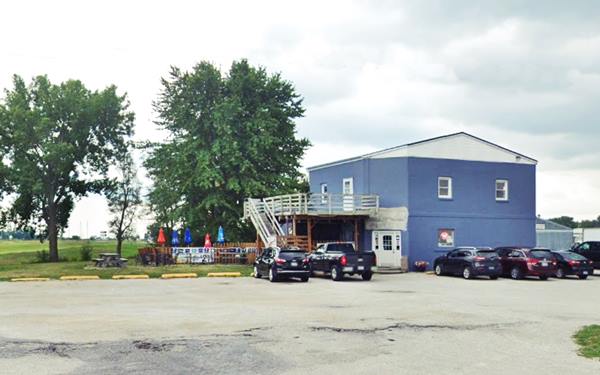 color, 2023 blue building, 2 stories, gable roof, cars parked