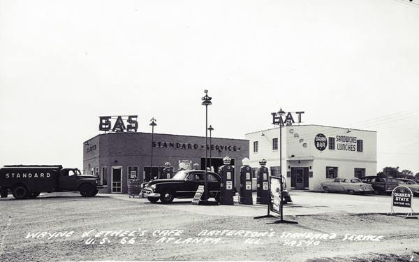 black and white 1950s left gas station, cars, sign and 6 pumps. Right: cafe, car, signs