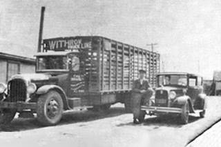 Withrow garage black and white 1920s. Truck with WHITROW TRUCK LINE written on box, man and car