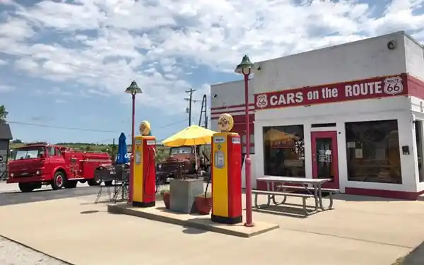 Cars on Route 66 gas station, Galena gas station, pumps, and three Cars movie characters