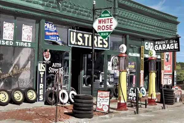 Bradshaw garage - 1941 photo colorized photo: old garage, gas pumps, tires, enamel signs
