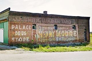 old painted advertisements on the red-brick wall
