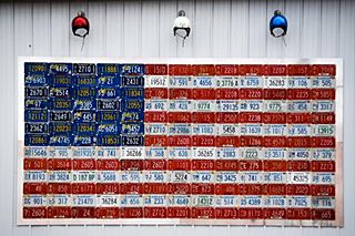 us flag made with licence plates on a wall