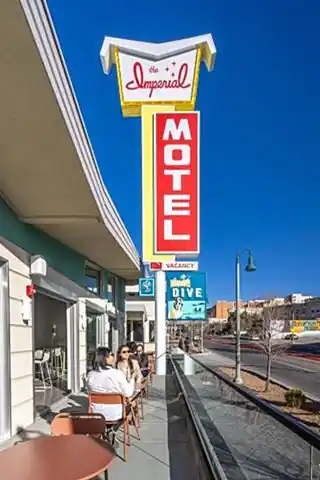 revamped motel, classic neon sign and people