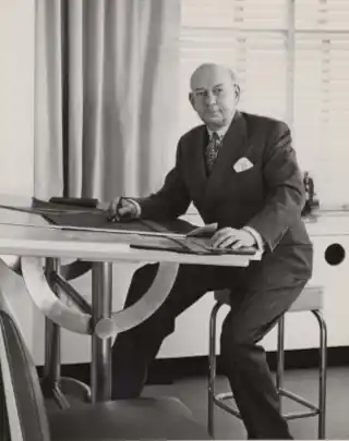 black white, man at drawing desk, in suit