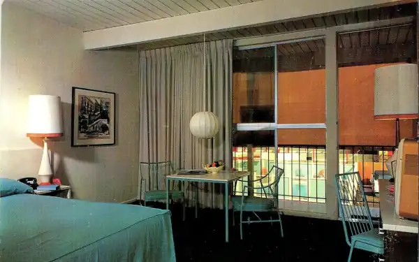 1960s interior of a motel room, TV, table, bed, chairs
