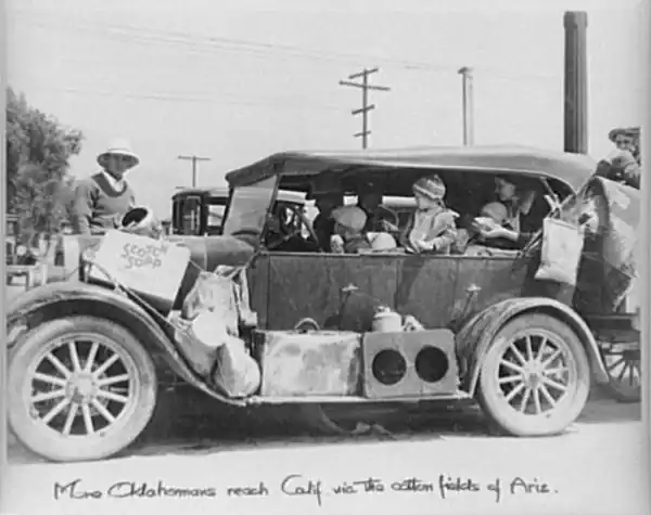 black n white photo, 1930, car with family with children Captioned: More Oklahomans reaches Calif. via the Ariz. cotton fields
