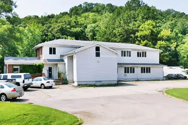 2-floor gable roof bldg. by highway