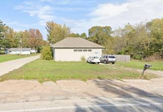 hipped roof building on a corner now a home