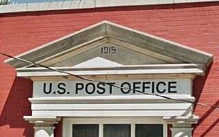 triangular pediment with words 1915 Post Office written on it