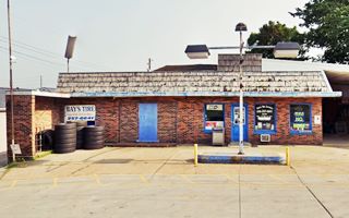 red brick flat roof former gas station now a tire shop