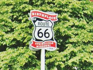 Birthplace of Route 66 sign, Springfield MO sign red and white: "Birthblace Springfield Missouri" and US 66 shield