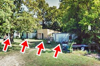 cabins in a semi-circle among trees and lawn