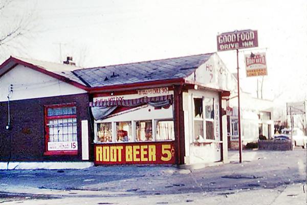 color picture gable roof building, 1950s car and signs