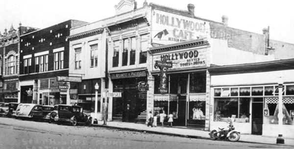 1930s picture black and white along 4th St. old cars and stores Carthage square