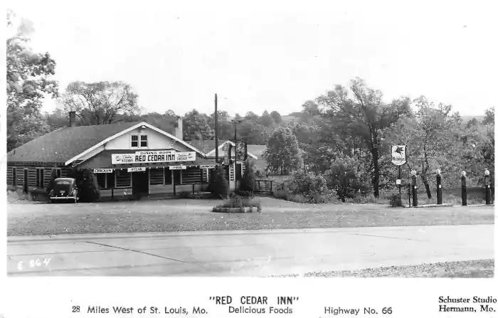 gable roof, log-cabin sytle with cars, signs black white 1934