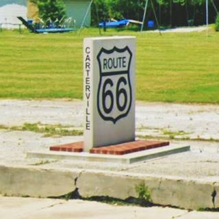Route 66 marker in Carterville Stone marker with US66 shield