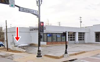 corner building with ramp and two garages