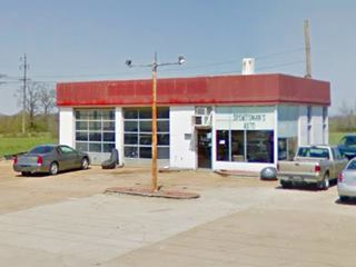 old gas station, with cars, now a repair shop