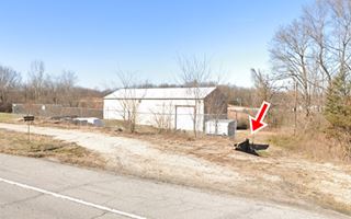 building next to highway and old retaining wall