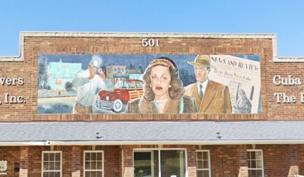 a mural depicting Bette Davis, newspaper and reporter