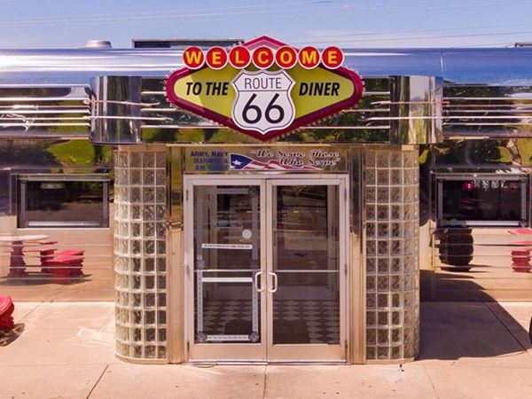 vintage looking stainless steel and glass diner entrance with neon sign