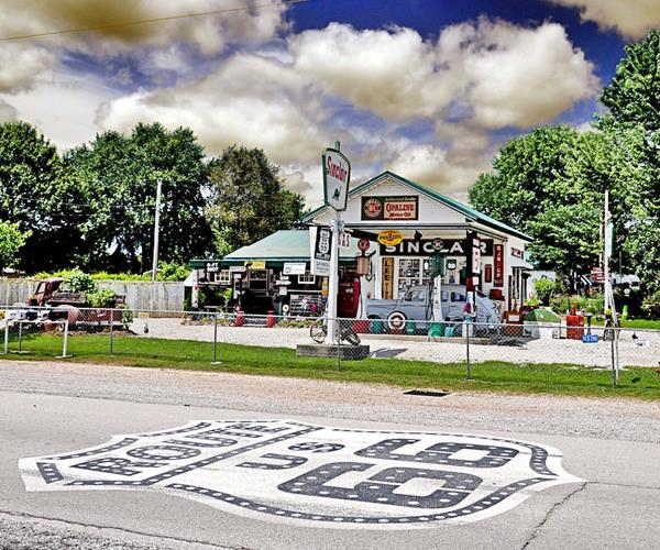 Route 66 painted on roadway and the Sinclair station behind it