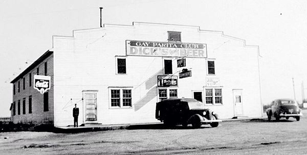 black and white photo wood ballrom and 1930s cars with Gay Parita Club written on billboard