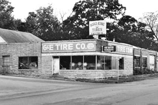 tire shop on a corner in a black and white photon