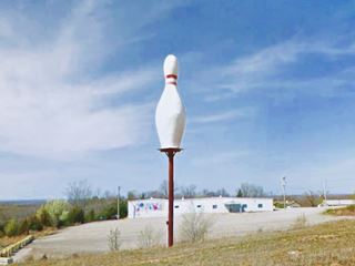 giant bowling pin atop a pole