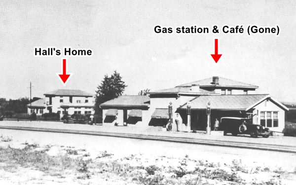 black and white photo, Route 66 in the foreground, and a series of buildings: cafe, gas station and home behind it