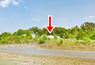 Harris’ gas station and cafe nowadays on Route 66 trees surround buildings on bluff by eastbound lanes of I-44