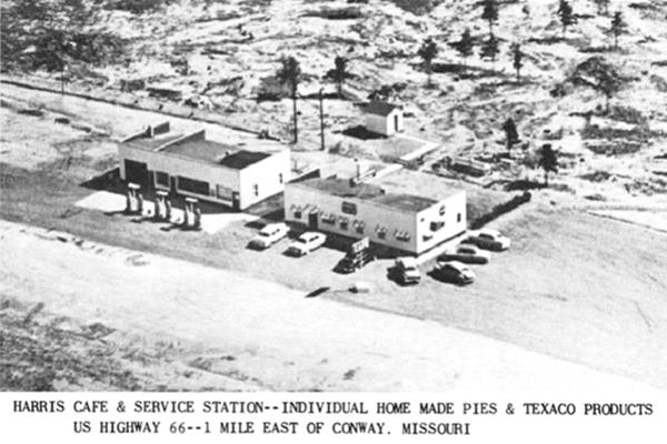 1950s black and white postcard box-shaped gas station with pumps, cafe and cars