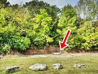 foundations of Hilltop Cafe nowadays US66 old concrete foundations and retaining wall in the grass
