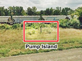 concrete foundations gas pumps in the weeds by freeway shoulder