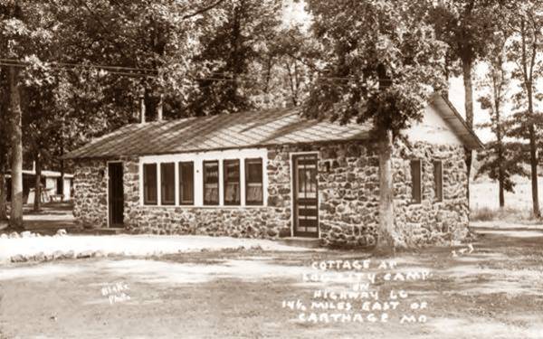 postcard with cabin by trees ca.1950