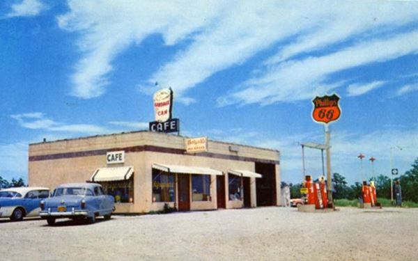 1950s color postcard box-shaped Phillips 66 station with pumps, sign, cafe and cars