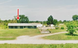 long gabled roof motel building in a field