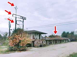 ruins of a motel and its neon sign