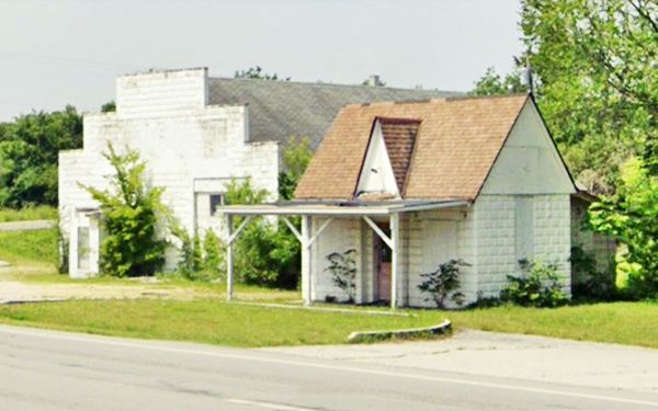 cottage style gabled gas station next to brick garage