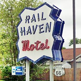 1950s neon sign white jagged panel dark blue letters spell: Rail Haven, word Motel in red