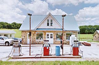 Rex Smith Gas Station & Cabins in Springfield Bypass 66 gable roofed stone faced 1933 filling station with trees and field behind it